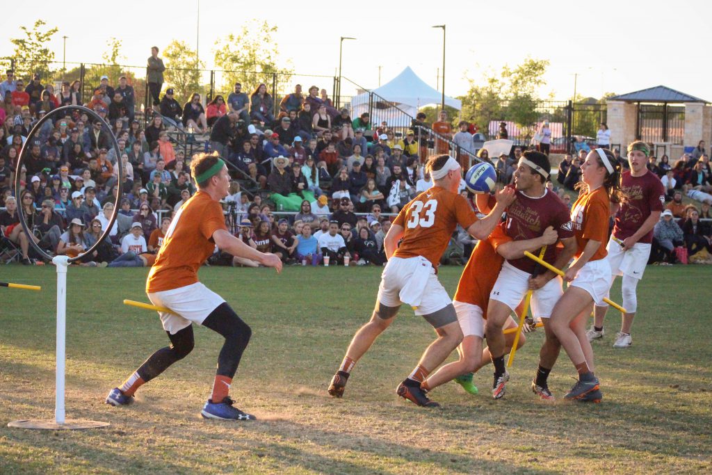 Quidditch players competing on field