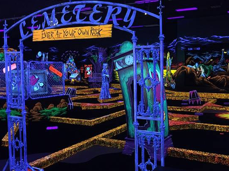 glow in the dark miniature golf course with haunted themed obstacles