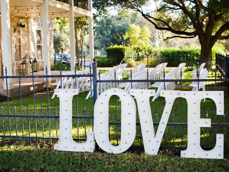 Outdoor Wedding settup with Love sign at fence