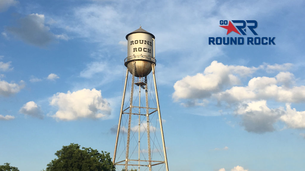 Round Rock Tower under a blue sky with clouds