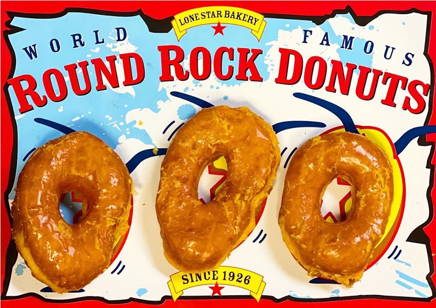 Three Round Rock Donuts sitting on Round Rock Donuts box