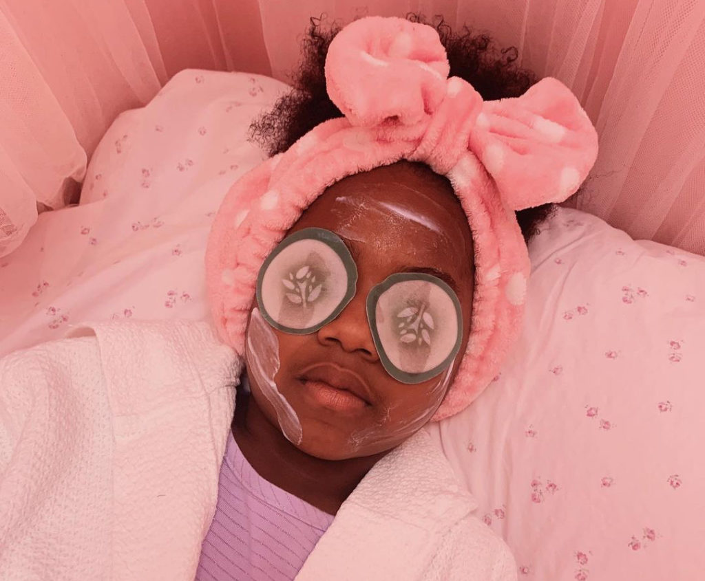 image of girl at the spa with cucumbers over her eyes. 
