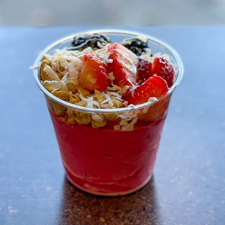 Photo of froyo topped with granola and berries. 