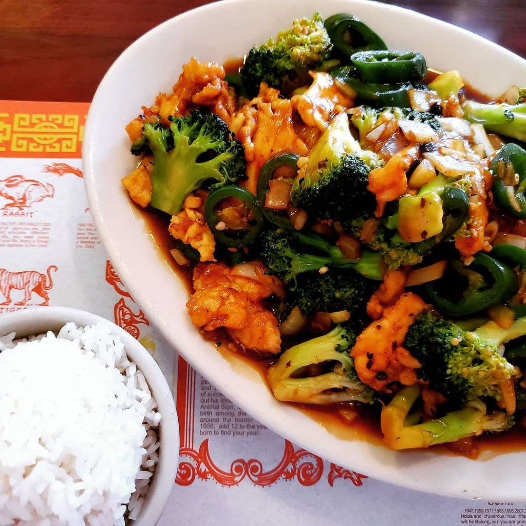 Photo of a bowl of chicken and broccoli and rice. 