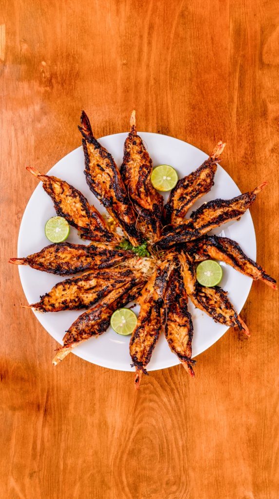 Cucarachas - authentic Sinaloan street-style favorite. Crispy, shell-on shrimp roasted over an open flame and dusted with our bold, smoky dry spice blend. Served blistering hot with fresh lime wedges for a fiery, mouth-watering crunch, simply The Best Cucarachas, Visit Us Today UnosMariscosOQue RoundRock, TX