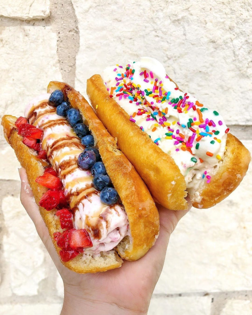 Picture of rolled ice cream in between a donut bun. 