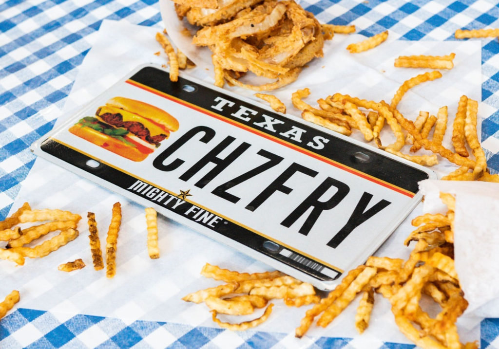 Photo of a license plate with chzfry on the front. French Fries in the background 