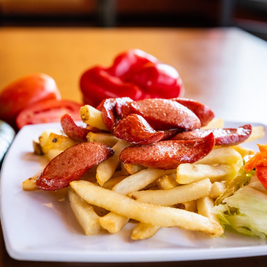 Photo of fries and sausage. 