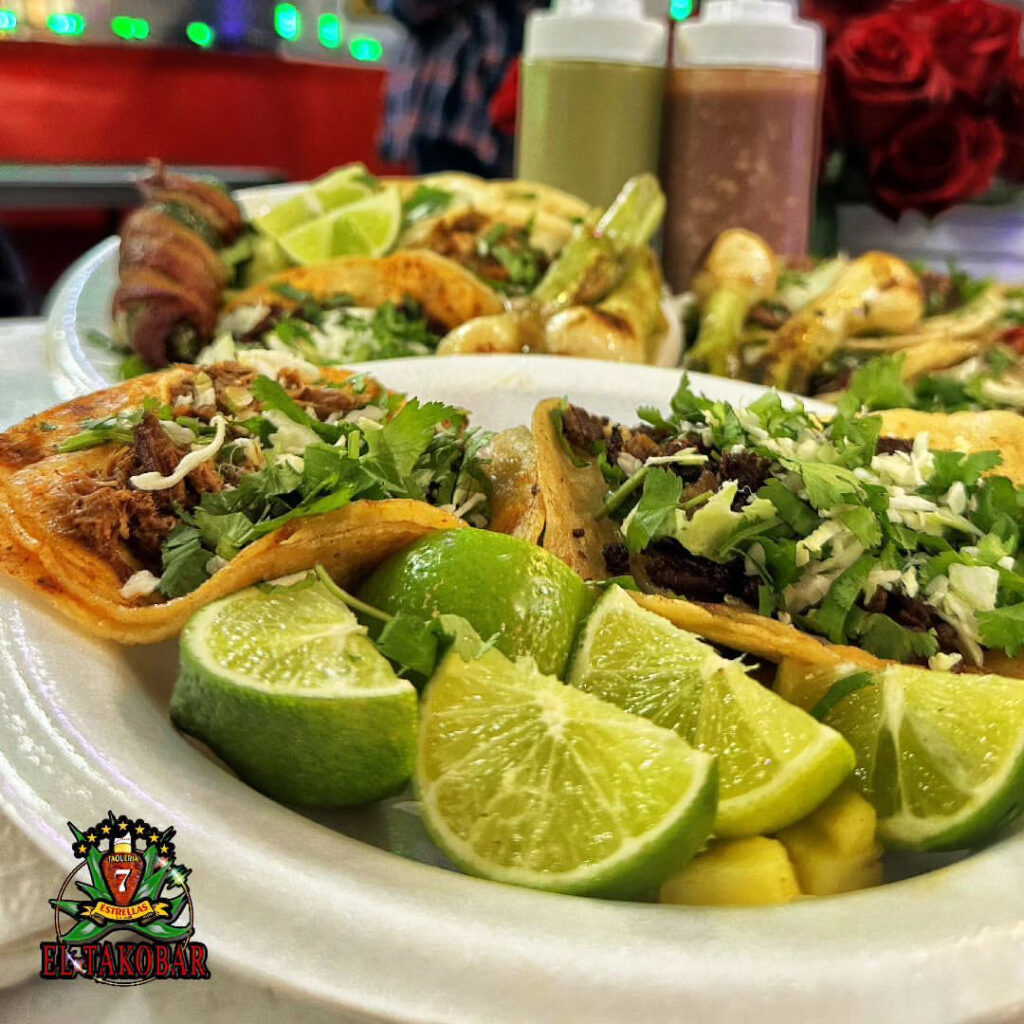 Photo of a plates of tacos with multiple limes. 