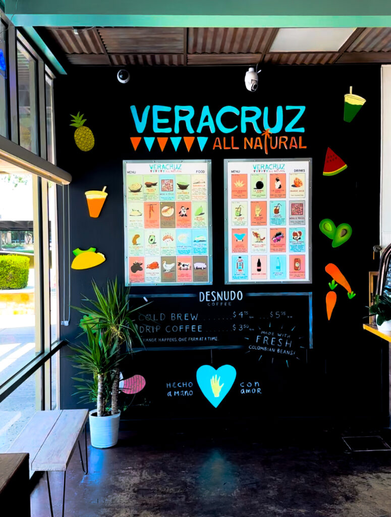 Photo of a sign at Veracruz All Natural with the menu and fruit. 