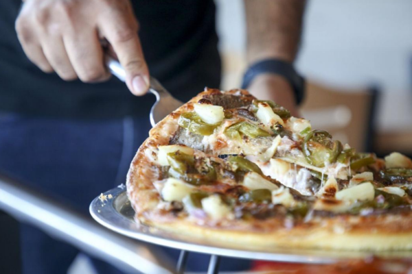 Customer serving pizza