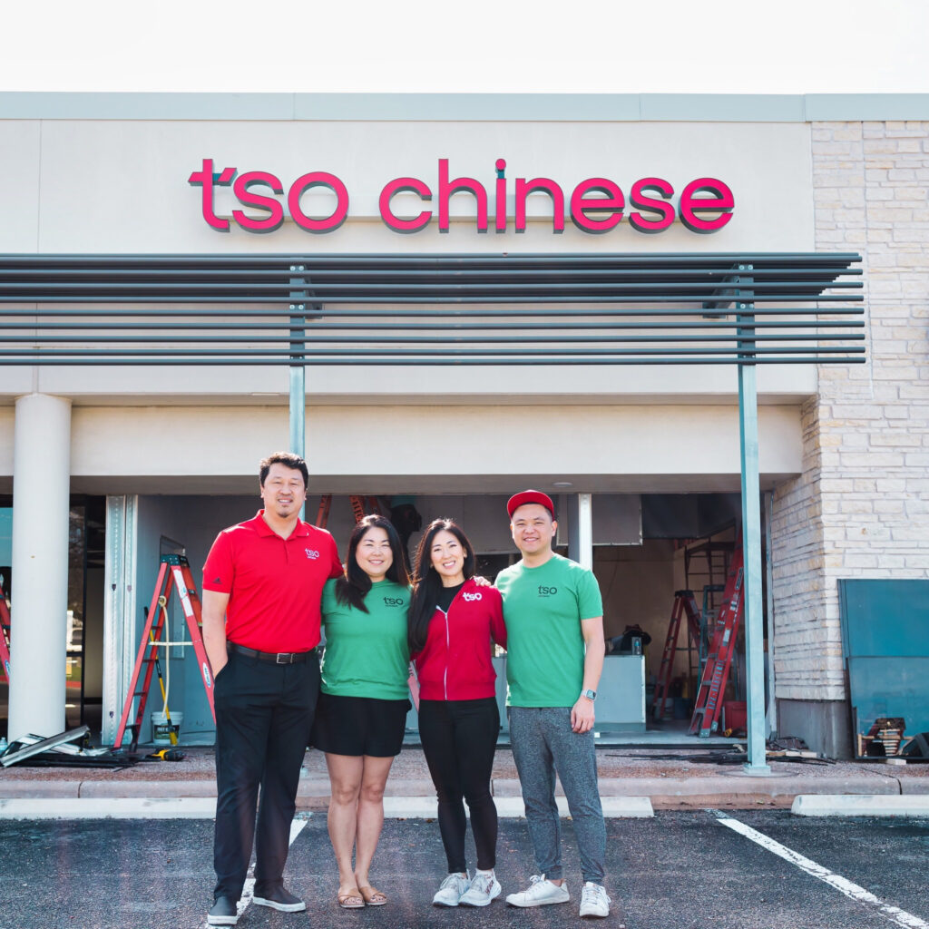 Photo of owners in front of TSO Chinese. 