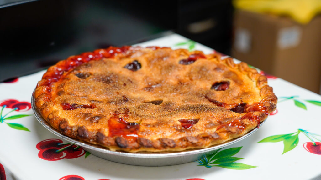 Famous cherry pie from Papi’s Pie with a golden crust and bubbling cherry filling.