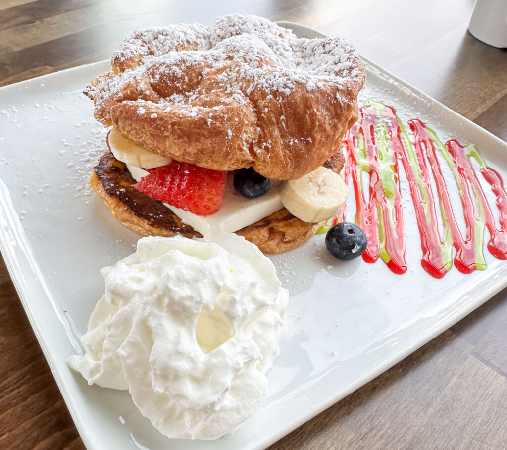 Pastry sandwich with fresh fruit, cream, and whipped topping at Home Kitchen.