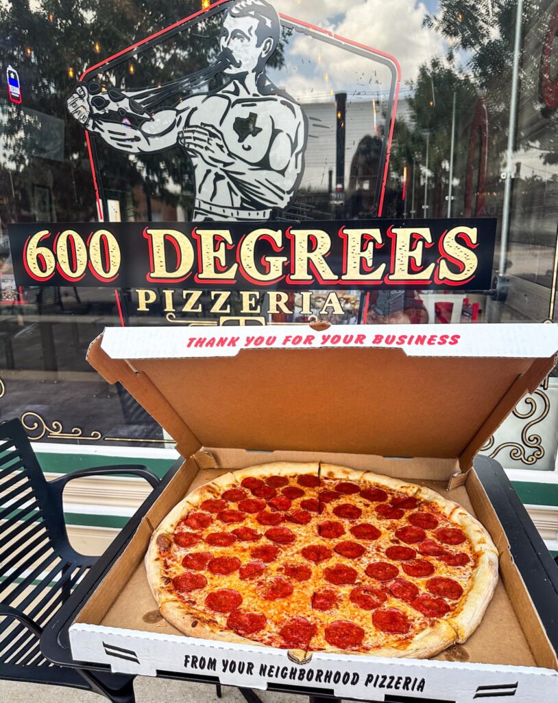 Large pepperoni pizza in an open box outside 600 Degrees Pizzeria.