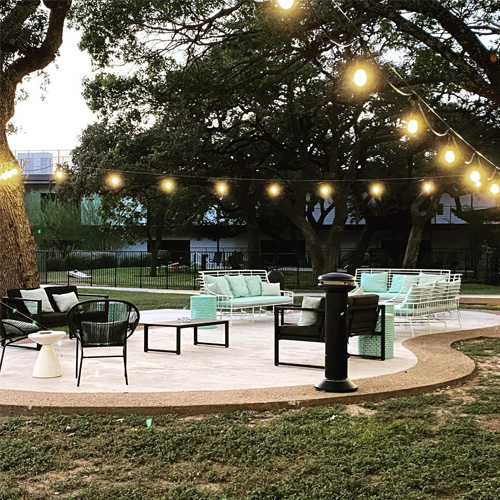 Patio area with couch and chairs at hotel