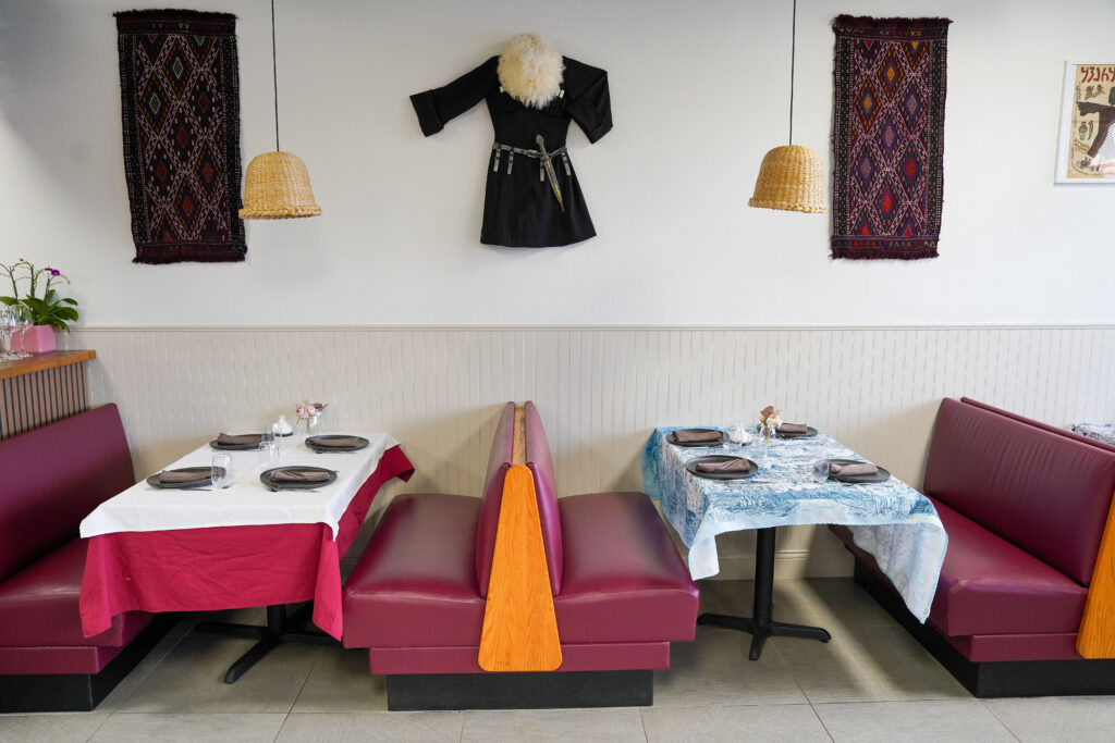 Indoor dining with Georgean rugs and attire