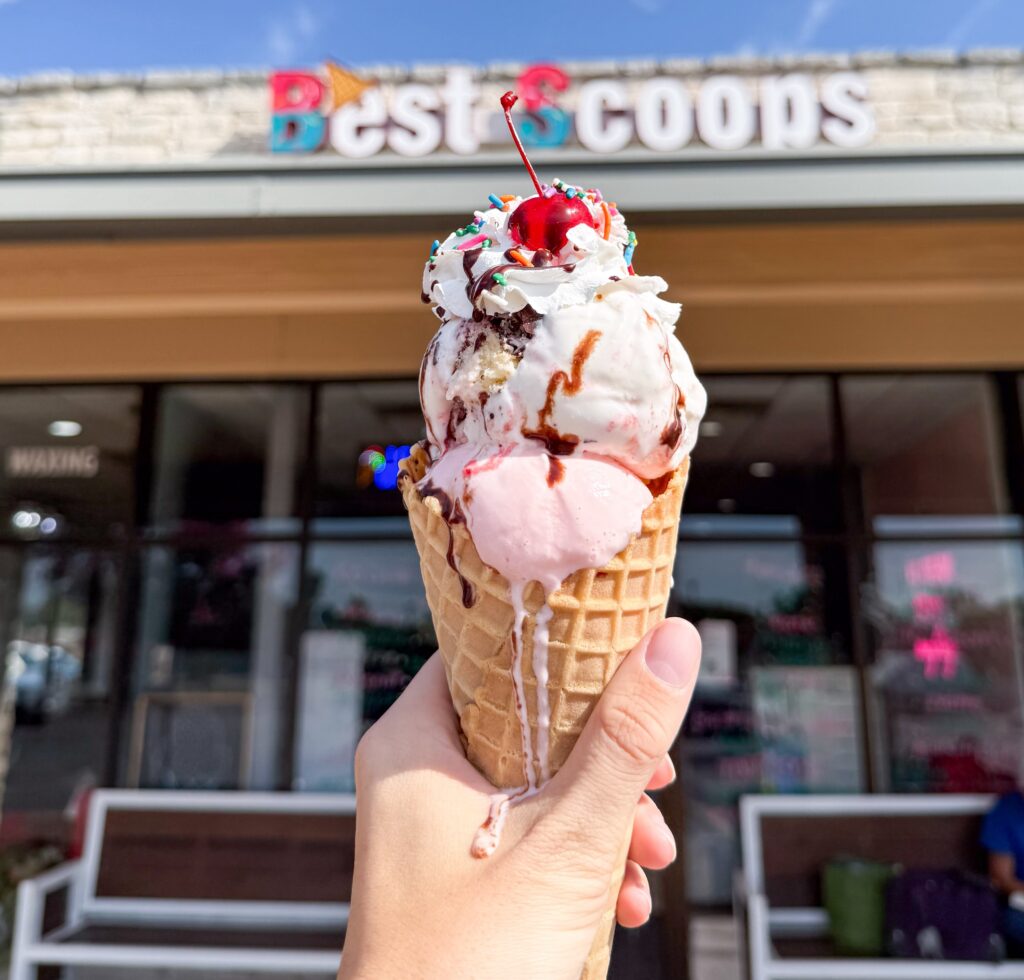 Homemade ice cream cone topped with whipped cream and a cherry at Best Scoops.