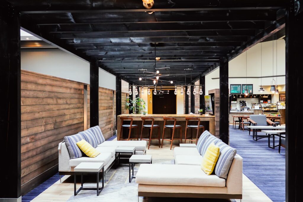 Modern Marriott Round Rock lobby with lounge seating, wood accents, and a bar area.