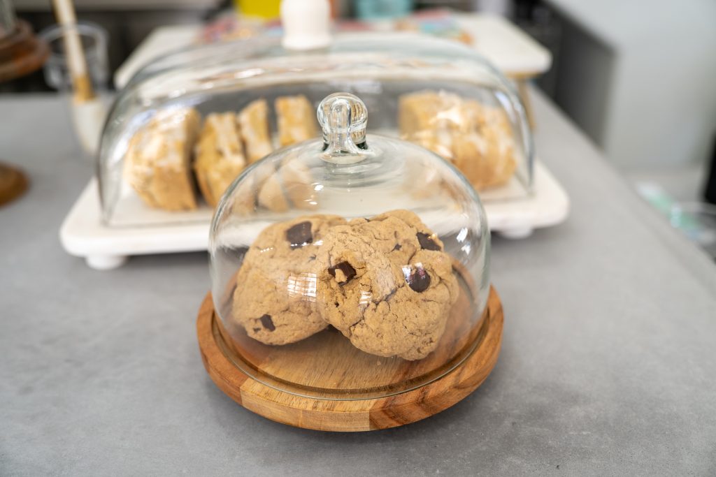 Chocolate Chip Cookies under a glass case.