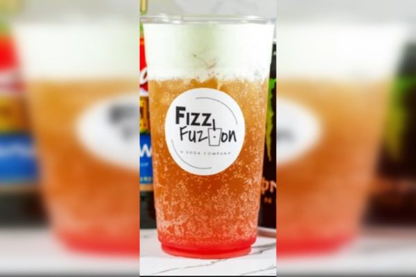 Layered orange and red fizzy drink in a Fizz Fuzion cup.