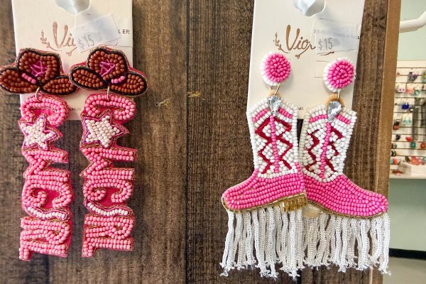 Beaded earrings featuring pink "Cowgirl" lettering and pink cowboy boots with white fringe.